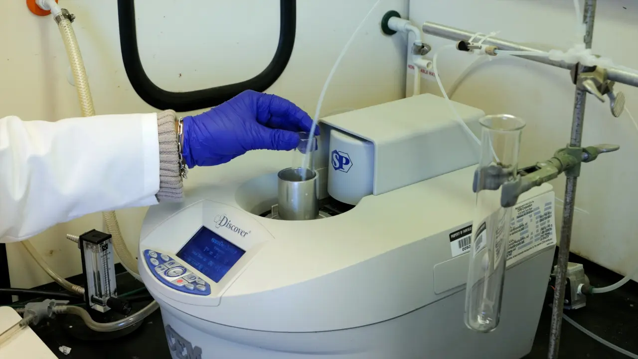 An Inexpensive Adaptation of a Commercial Microwave Reactor for Solid Phase Peptide Synthesis